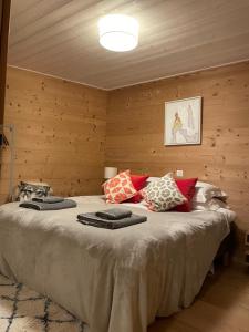 a bedroom with a large bed with pillows on it at Chalet Moose in Morzine