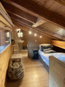 a bedroom with a bed in a wooden cabin at Chalet Moose in Morzine