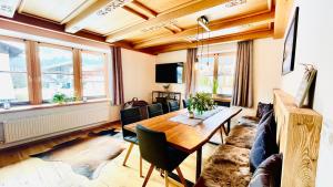 a living room with a table and a couch at Chalet Hoamat Leben in Leogang