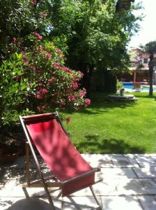 una silla roja sentada en un patio en un patio en La Cathare, en Lézignan-Corbières