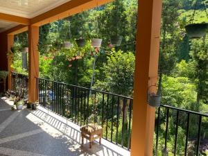 a balcony with a view of a garden at Venera's Guest House in Batumi