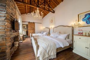 a bedroom with two beds and a brick wall at Boke Hotel Xihu in Hangzhou