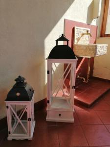 two lanterns sitting on the floor in a room at Lo Chalet in Ponte Galeria