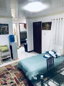 a bedroom with a large bed and a chair at THE MANSION- Near NAIA Airport Terminal PASAY in Manila