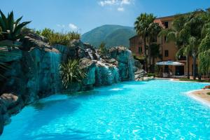 a pool in a resort with a waterfall at Hotel Villa Albani in Nocera Superiore