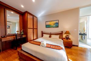 a bedroom with a bed and a desk and a mirror at Hua Hin Horizon in Hua Hin +38 photos