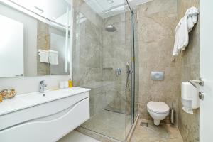ein Badezimmer mit Dusche, Toilette und Waschbecken in der Unterkunft Belgrade Inn Garni Hotel in Belgrad