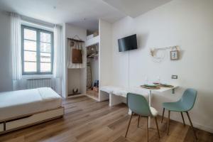 a bedroom with a bed and a table and chairs at Il Nido Tra Le Mura - by MyHomeInComo in Como