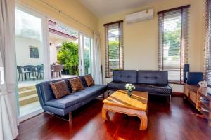 a living room with a couch and a coffee table at Hua Hin Horizon in Hua Hin