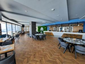 a restaurant with tables and chairs and a bar at Sunrise Beach Suite B7 in Kalecik