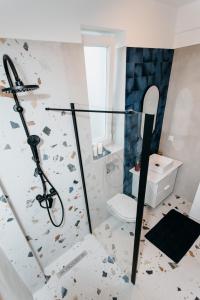 a bathroom with a shower and a toilet at Evo Residence Migdalului in Cluj-Napoca