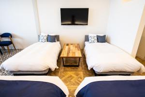 Postel nebo postele na pokoji v ubytování BAYSIDE KANAYA