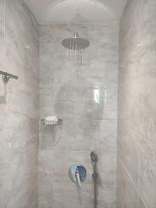 a bathroom with a shower with a chandelier at Anerada sunset in Ano Meria