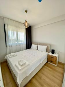 a bedroom with a large bed with white sheets at NAUTILUS UNIQUE in Dalyanköy
