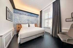 a hotel room with a bed and a window at Hyperion Hotel Salzburg in Salzburg