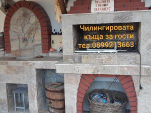 a stone pizza oven with a basket in it at Chilingirovata Kashta in Pavel Banya