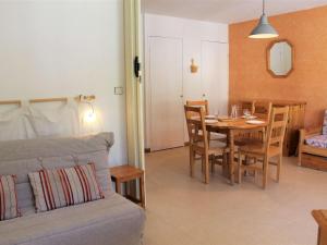 a living room with a table and a couch at Appartement Vars, 1 pièce, 6 personnes - FR-1-330B-138 in Vars