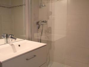 a bathroom with a shower with a sink and a mirror at Appartement Vars, 1 pièce, 6 personnes - FR-1-330B-138 in Vars