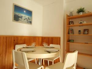een eetkamer met een witte tafel en witte stoelen bij Appartement Saint-Chaffrey , 2 pièces, 6 personnes - FR-1-330E-33 in Saint-Chaffrey