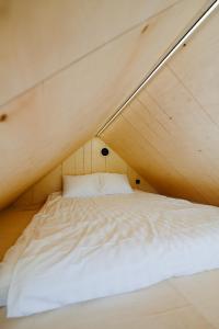 a bed in a tent in a room at Unique Tiny House at Saaremaa Golf & Country Club in Kuressaare