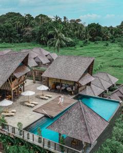 an aerial view of a resort with a swimming pool at Tejaprana Bisma - CHSE Certified in Ubud