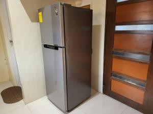 a refrigerator in a room next to a door at Resort-type, spacious 1 bedroom condo in Kandi. in Angeles