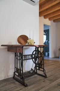 a table with a wooden top on top of it at Casale San Pietro in Palmanova