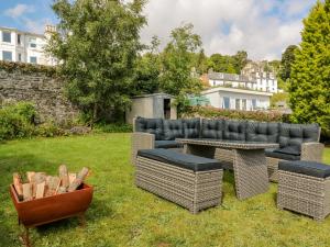 a backyard with a couch and chairs and a table at Argyle House in Rothesay