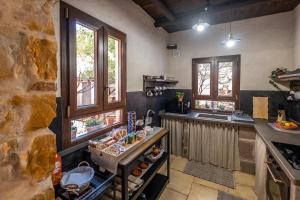 a kitchen with a counter and some windows at Il Rifugio dei Minatori in Iglesias
