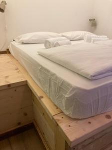 a bed sitting on top of a wooden platform at Ostello Antagonisti in Melle