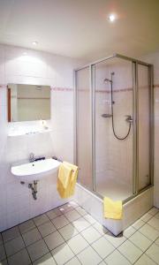 a bathroom with a shower and a sink at Hotel Am Quellberg in Recklinghausen