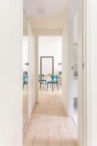 a hallway with white walls and a dining room with a table at Casa Cadrega in Milan
