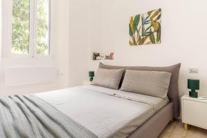 a white bedroom with a bed with white sheets at Casa Cadrega in Milan