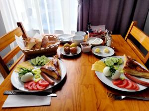 a wooden table with plates of food on it at RP HOTEL (NEW) in Yerevan