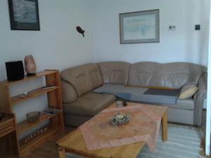 a living room with a couch and a coffee table at Balatonberényi Vendégház in Balatonberény