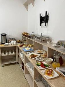 a kitchen with many plates of food on a counter at Xadijam Hotel in Bukhara