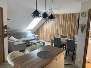 a living room with a couch and a table at APARTMENT DOR-Ali u Ali in Żubracze