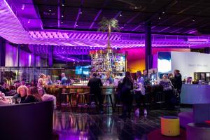 a bar in a room with a crowd of people at Quality Hotel Globe in Stockholm