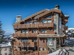 a large wooden house with a deck on the side of it at Appartement Courchevel 1650, 3 pièces, 6 personnes - FR-1-563-8 in Courchevel