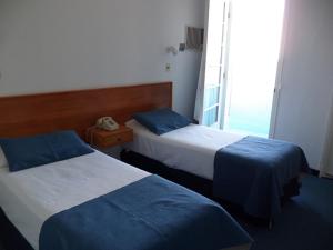 Voodi või voodid majutusasutuse Hotel Escorial toas