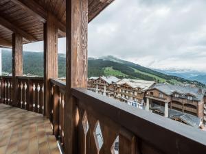 a balcony with a view of a town at Studio Courchevel 1650, 1 pièce, 5 personnes - FR-1-563-91 in Courchevel