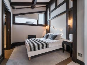 a bedroom with a bed and a large window at Splendide appartement centre Courchevel, 4 chambres, parking inclus - FR-1-563-64 in Courchevel