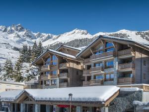 a large apartment building with snow on the mountains at Appartement Courchevel 1650, 5 pièces, 8 personnes - FR-1-563-29 in Courchevel