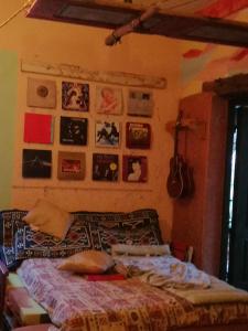 a bedroom with a bed and posters on the wall at Krasberry Ježev brlog in Komen