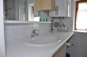 a white bathroom with a sink and a window at Ferienhaus Ackerl in Mitterretzbach +20 photos