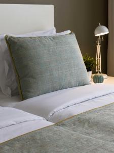 uma cama com uma almofada verde em cima em Oasis Tarrafal Alfandega Suites em Tarrafal