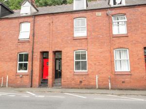 a red brick building with a red door at 4 Tanyrallt Terrace in Llangollen