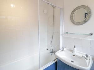 a bathroom with a sink and a shower at 4 Tanyrallt Terrace in Llangollen