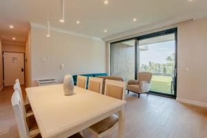 a dining room and living room with a table and chairs at Carmen Residence Apartments in Opatija