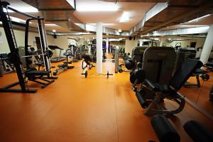 a gym with several rows of treadmills and machines at Hotel Marinšek in Naklo